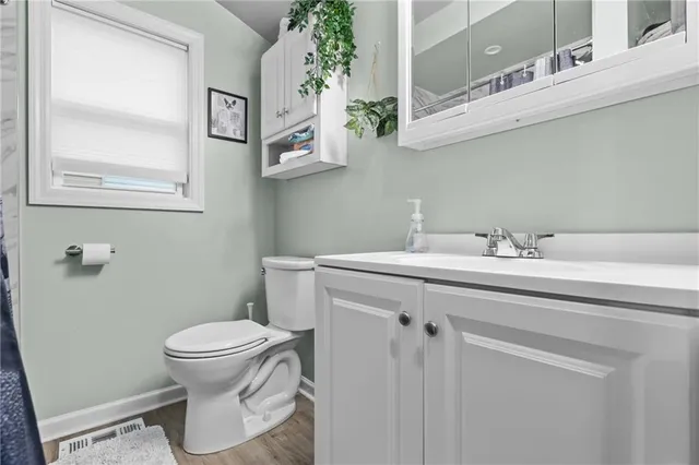 a bathroom with a sink mirror vanity and toilet