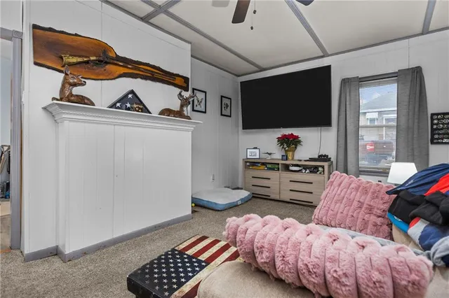 a bedroom with furniture and a flat screen tv