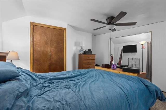 a bedroom with a bed and a large mirror