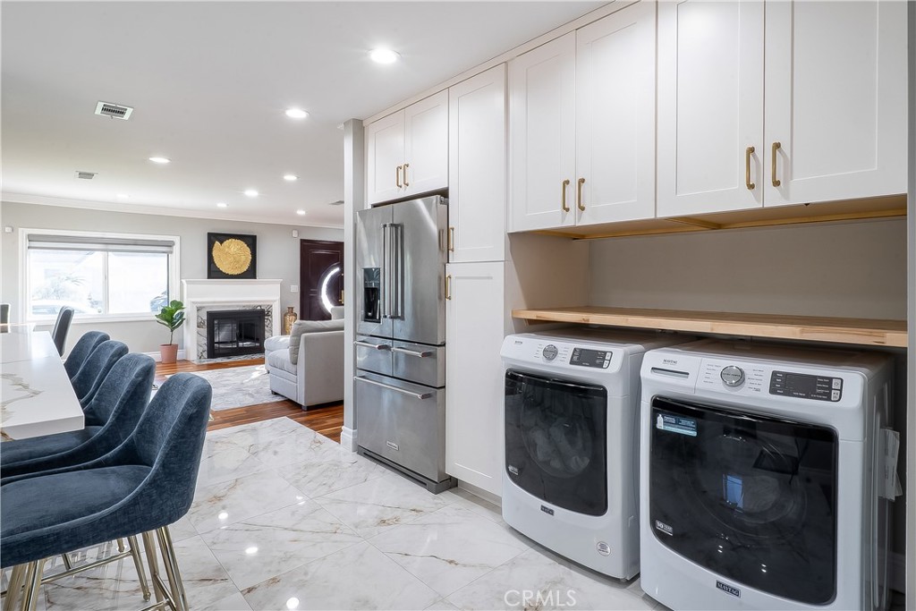 5339 East Greenmeadow Road Long Beach, CA 90808 - Photo 11 of 34 a kitchen with stainless steel appliances a stove a microwave and a refrigerator