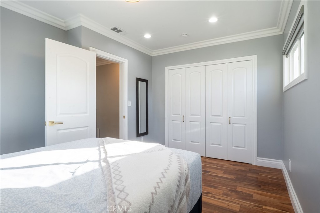 5339 East Greenmeadow Road Long Beach, CA 90808 - Photo 14 of 34 a spacious bedroom with a bed and a dresser