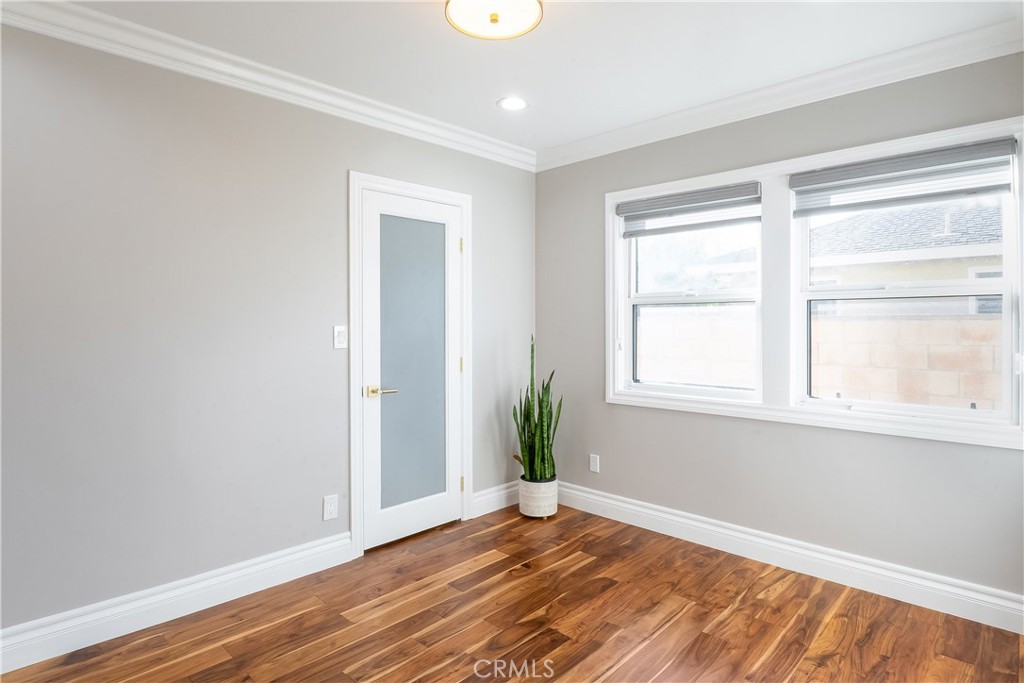 5339 East Greenmeadow Road Long Beach, CA 90808 - Photo 17 of 34 a view of an empty room with wooden floor and a window