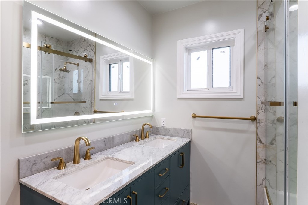 5339 East Greenmeadow Road Long Beach, CA 90808 - Photo 18 of 34 a bathroom with a sink and a mirror