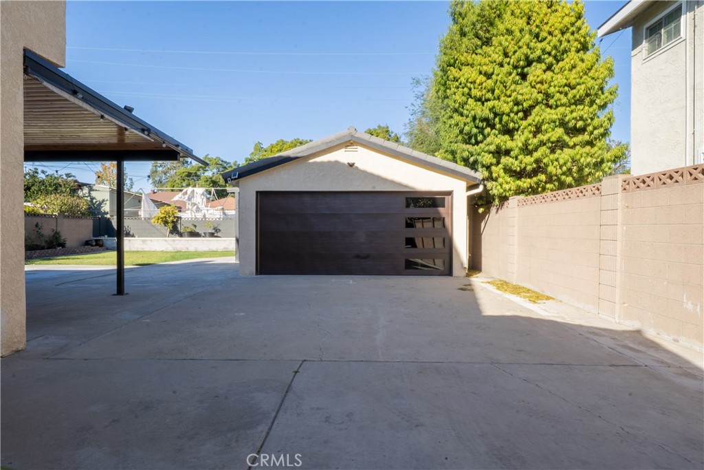 5339 East Greenmeadow Road Long Beach, CA 90808 - Photo 23 of 34 a view of a house with a garage and yard