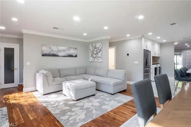 a living room with furniture and a large mirror
