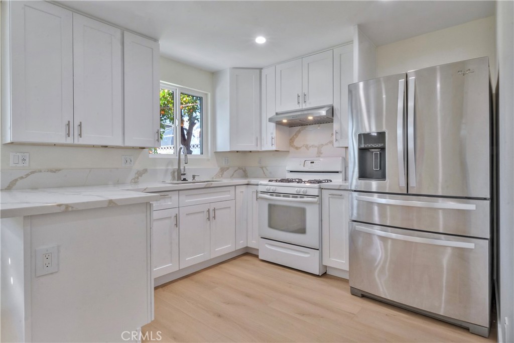 5339 East Greenmeadow Road Long Beach, CA 90808 - Photo 31 of 34 a kitchen with appliances cabinets and a sink
