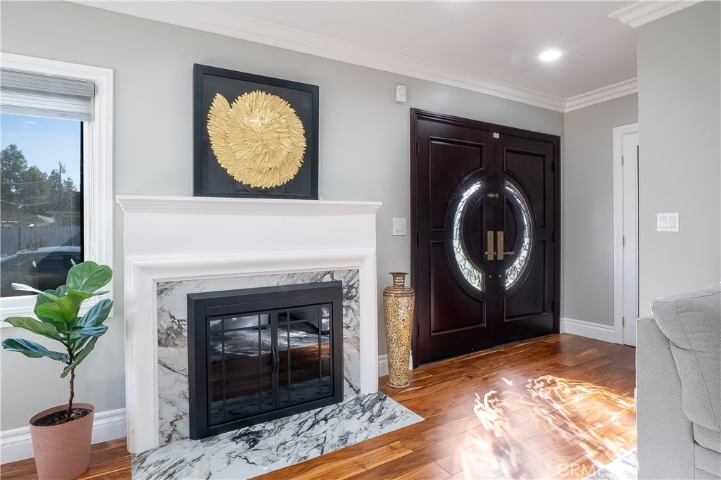 5339 East Greenmeadow Road Long Beach, CA 90808 - Photo 6 of 34 a living room with a fireplace and a potted plant