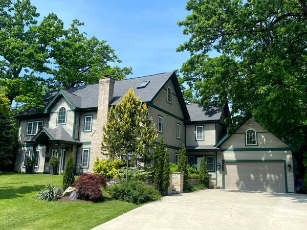 a front view of a house with a garden