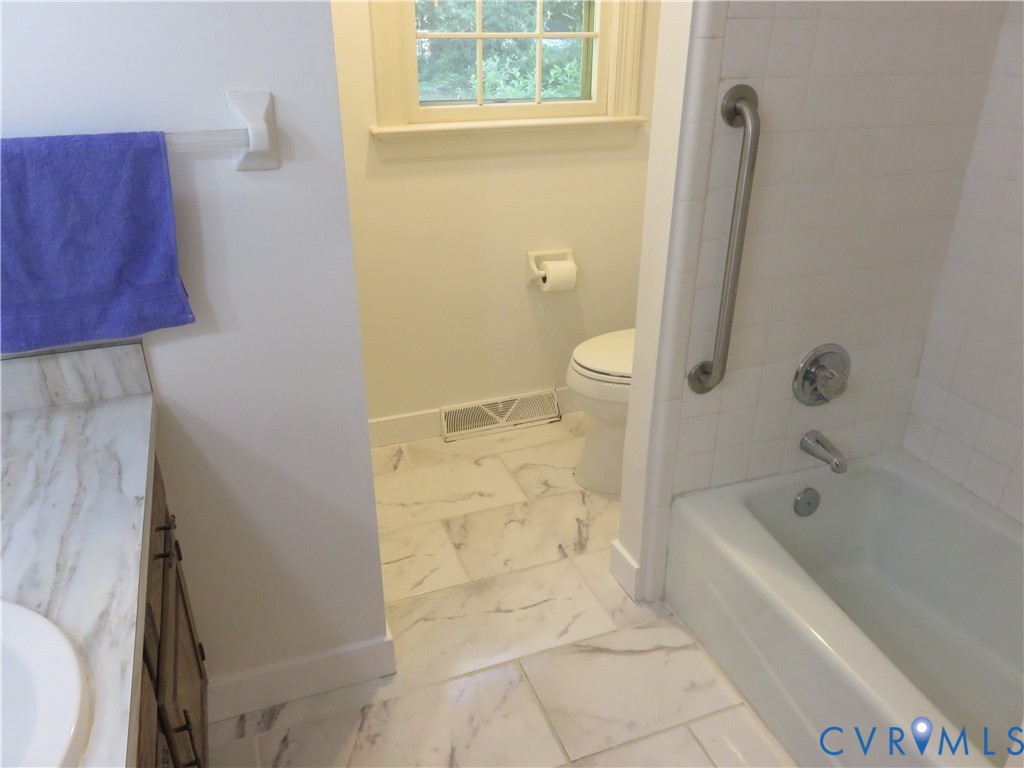 8379 Quailfield Road Mechanicsville, VA 23116 - Photo 32 of 56 a bathroom with a bathtub and a shower
