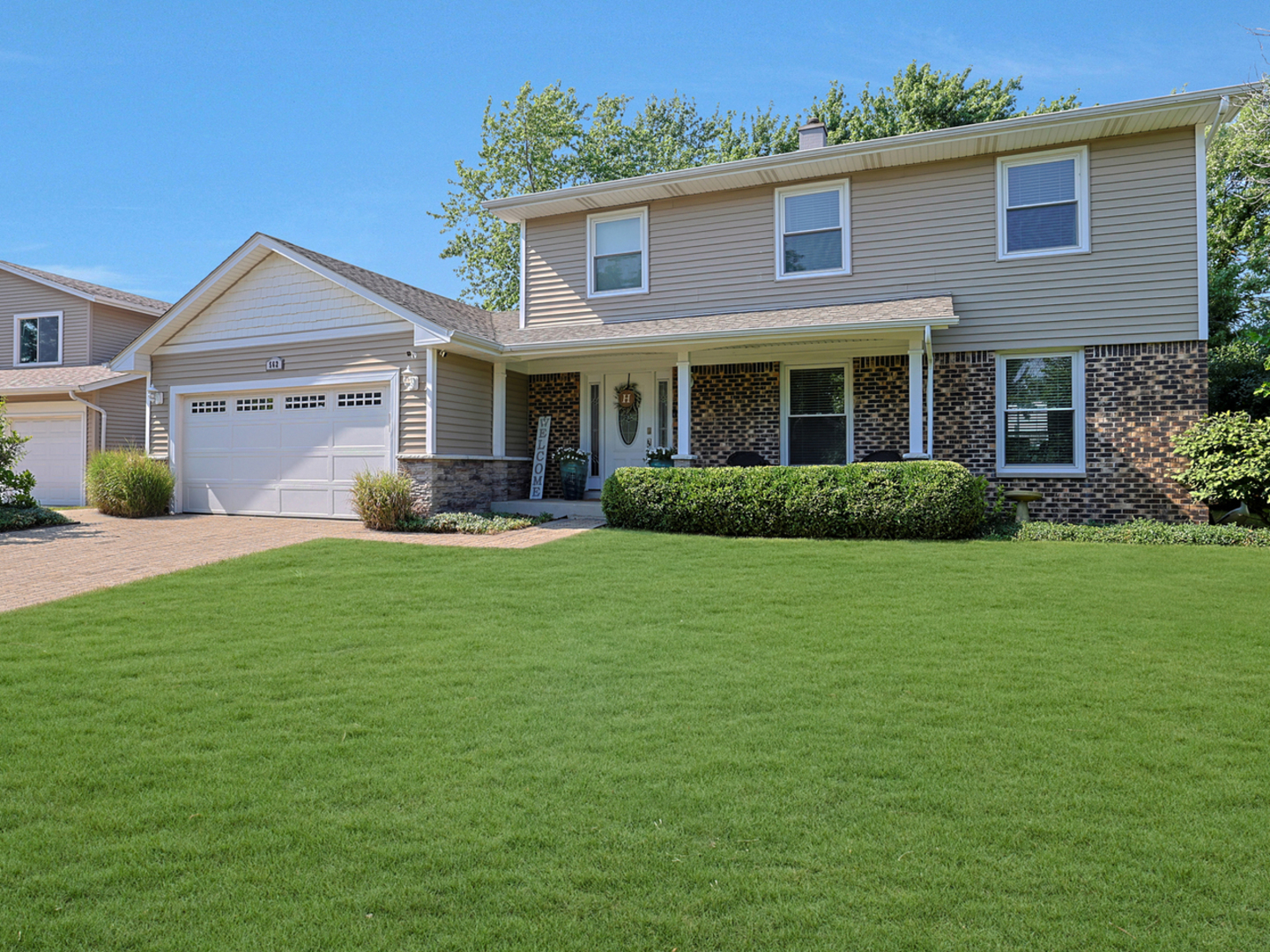 a front view of a house with a garden