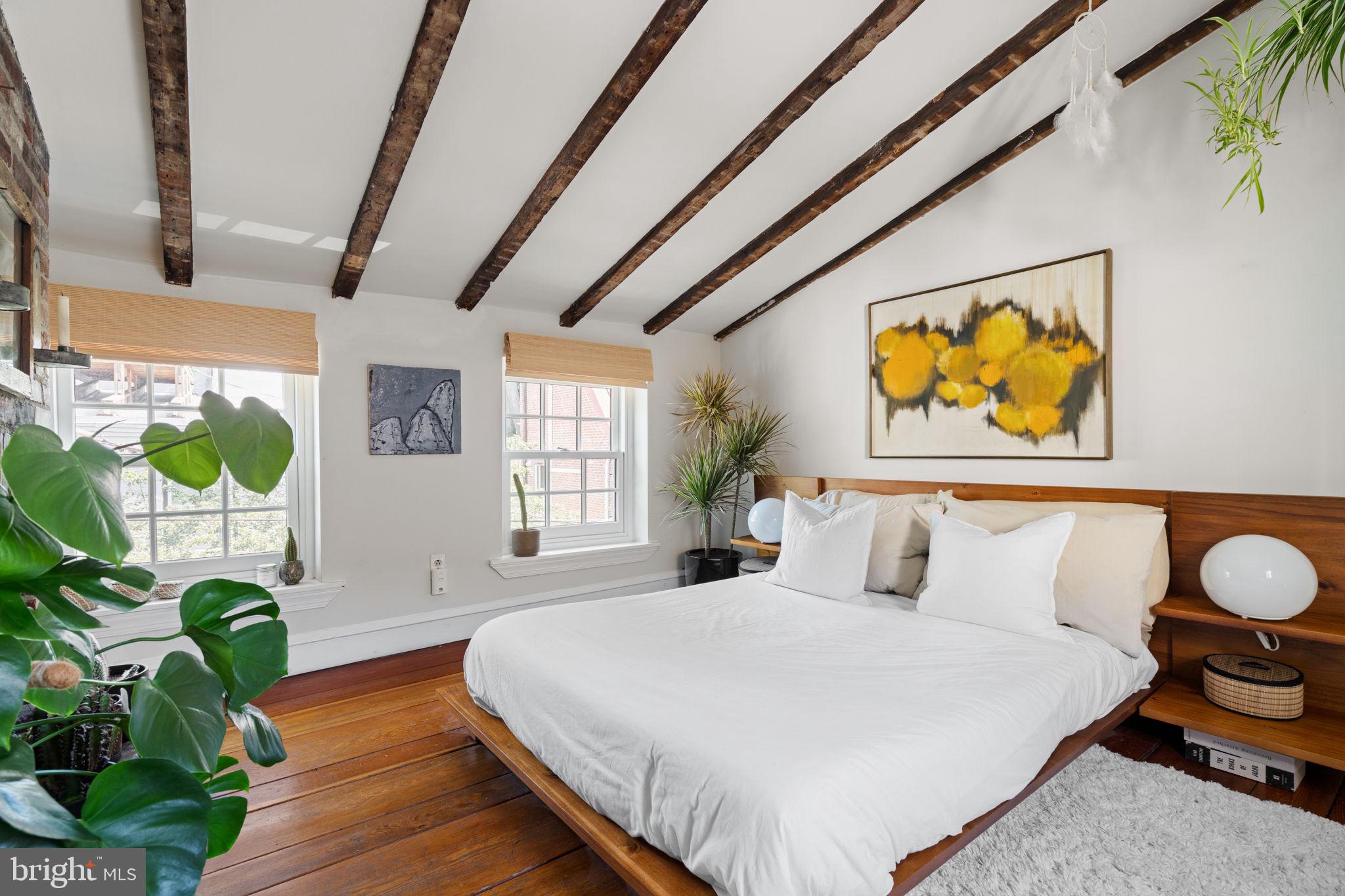 142 Carpenter Street Philadelphia, PA 19147 - Photo 43 of 49 a bedroom with a bed table and a window