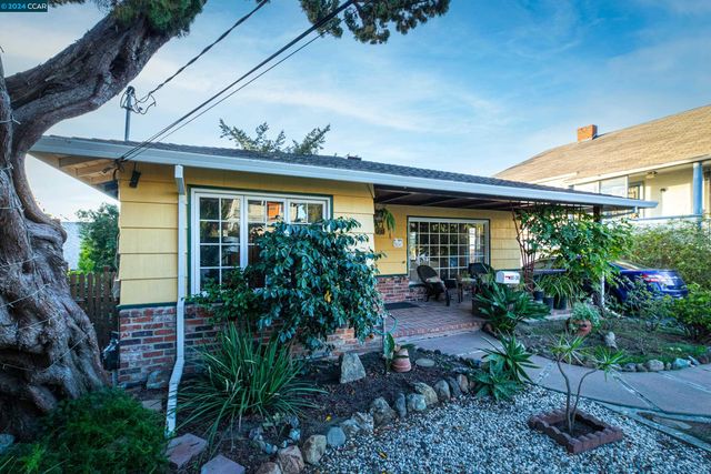 a house with potted plants in front of it