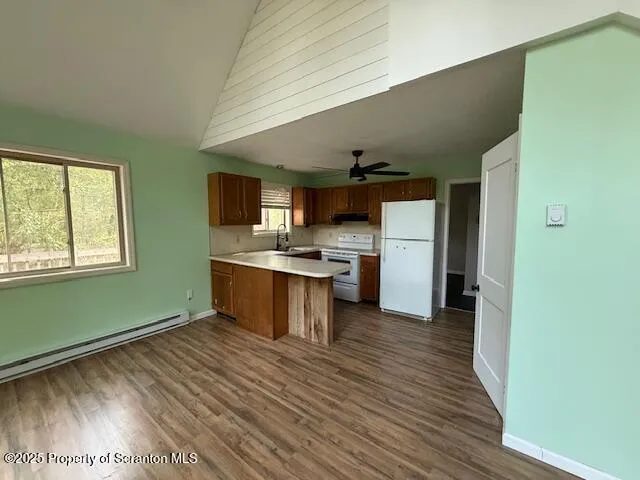 a kitchen with a refrigerator and a stove top oven