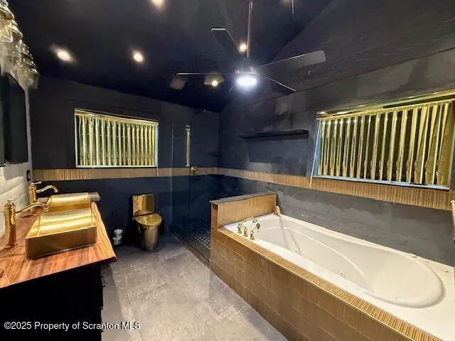 a bathroom with a tub sink and a large mirror