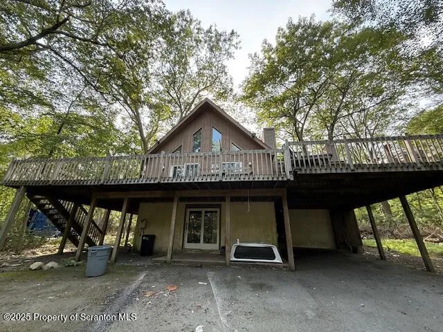 a view of a chairs and table in front of house