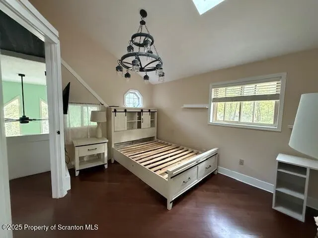 a bedroom with furniture and wooden floor