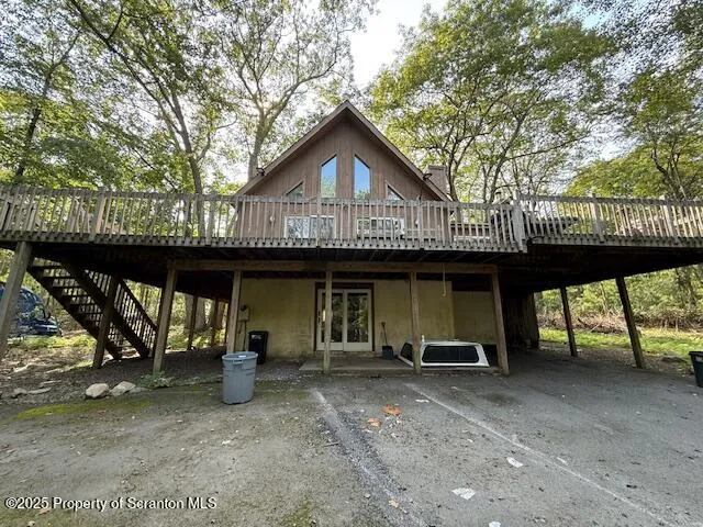 a view of a house with large windows and a small yard
