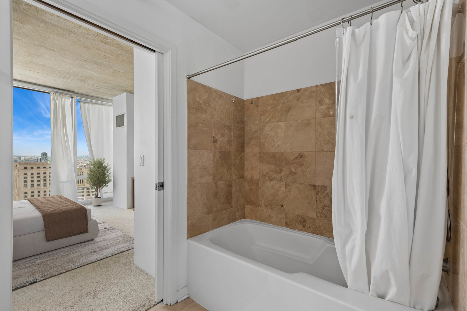 611 South Wells Street, Unit 2904 Chicago, IL 60607 - Photo 14 of 18 a bathroom with a bathtub and a shower
