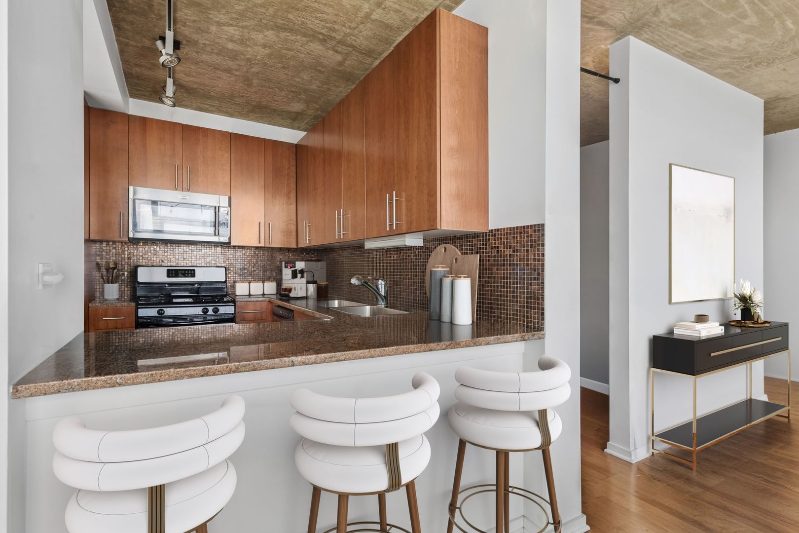 611 South Wells Street, Unit 2904 Chicago, IL 60607 - Photo 6 of 18 a kitchen with a sink and chairs