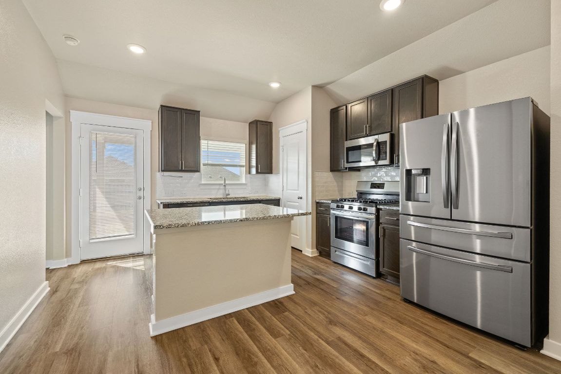 1304 Salt Lick Drive Georgetown, TX 78633 - Photo 12 of 40 a kitchen with stainless steel appliances granite countertop a refrigerator stove and oven