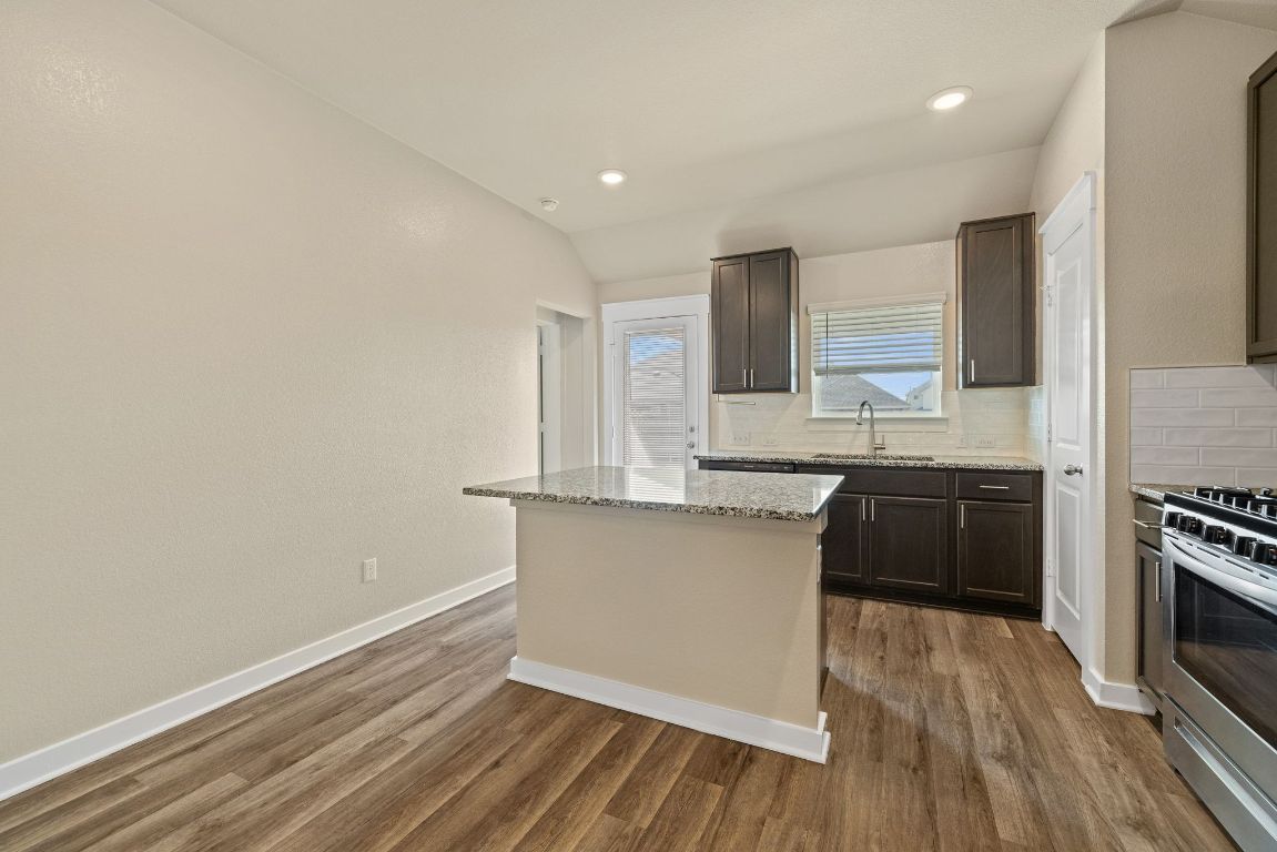 1304 Salt Lick Drive Georgetown, TX 78633 - Photo 13 of 40 a kitchen with granite countertop a sink cabinets and stainless steel appliances
