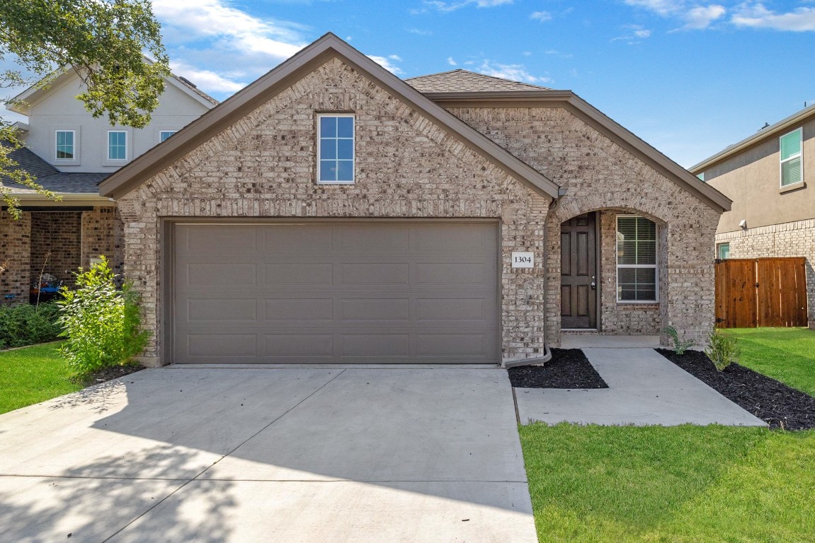 1304 Salt Lick Drive Georgetown, TX 78633 - Photo 3 of 40 a front view of a house with a yard and garage