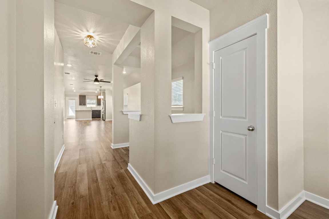 1304 Salt Lick Drive Georgetown, TX 78633 - Photo 6 of 40 a view of a hallway with wooden floor and a bathroom