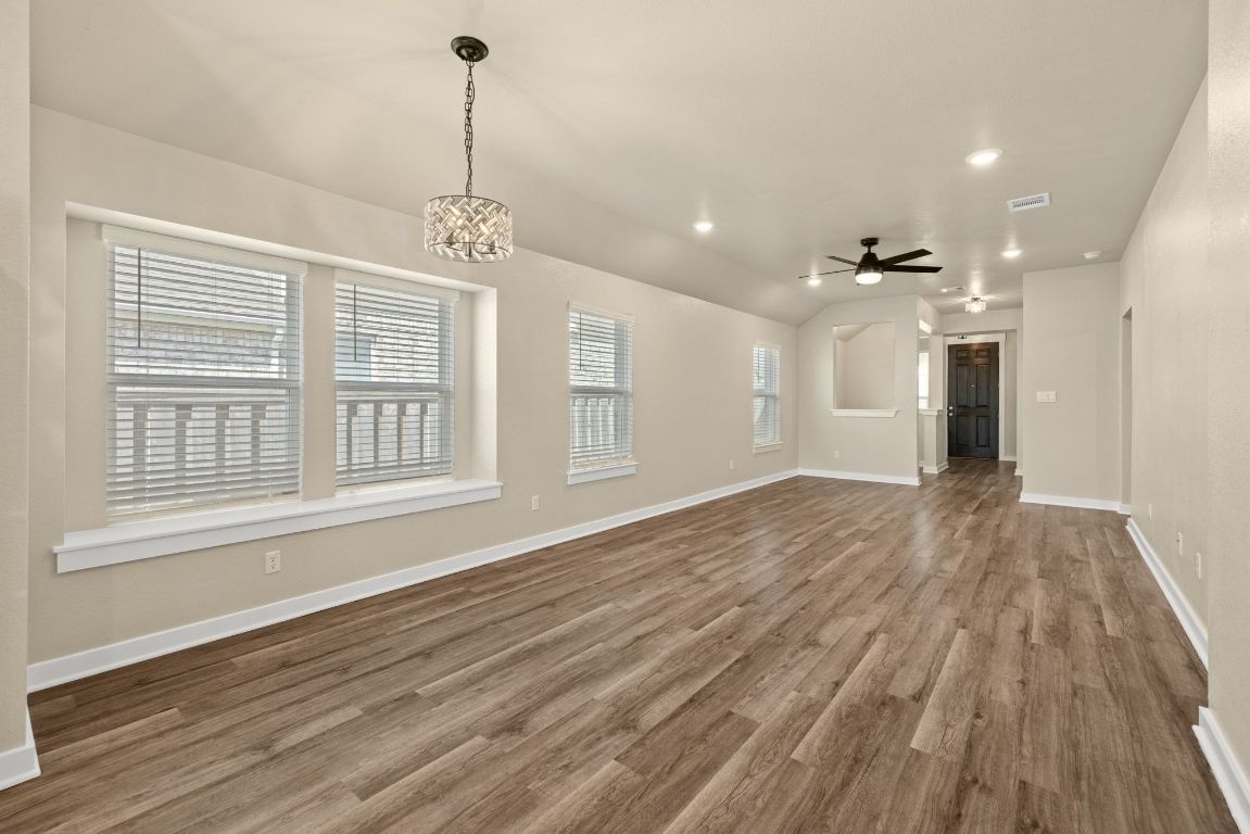 1304 Salt Lick Drive Georgetown, TX 78633 - Photo 10 of 40 a view of an empty room with wooden floor and a window