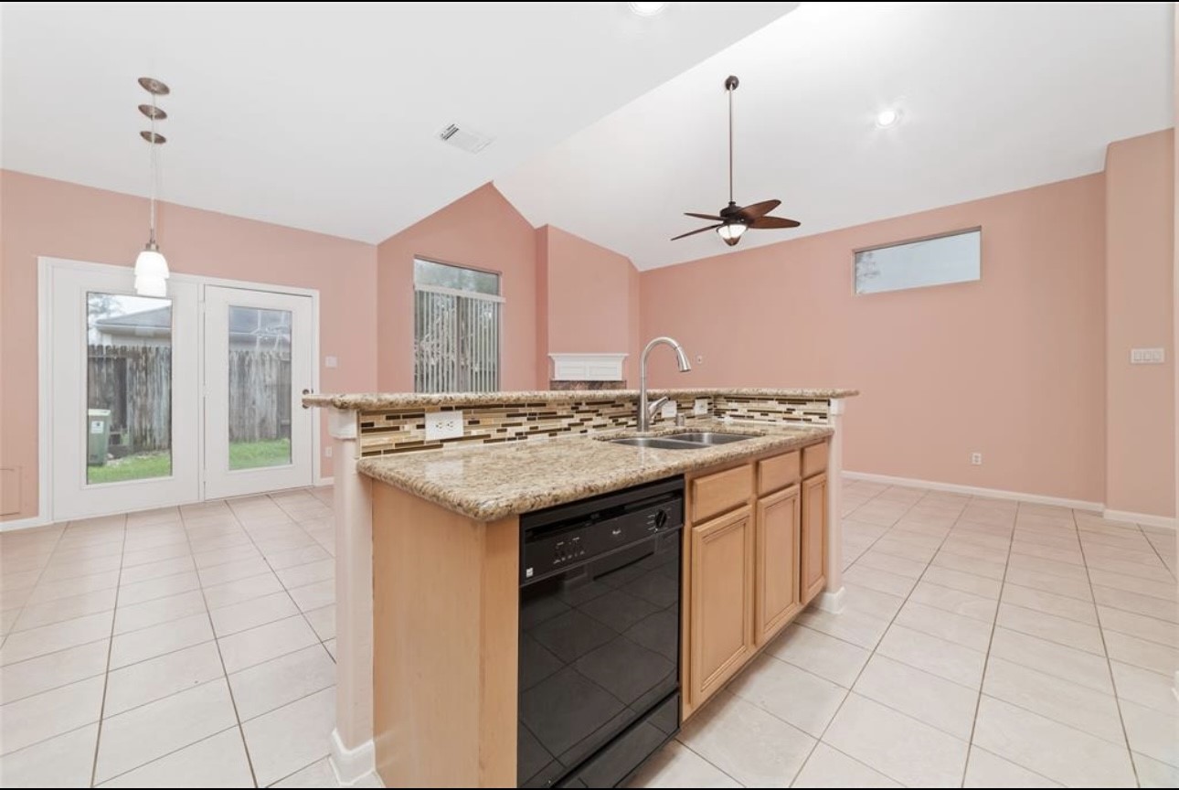18715 Scented Candle Way Spring, TX 77388 - Photo 13 of 24 a kitchen with stainless steel appliances granite countertop a sink and a stove