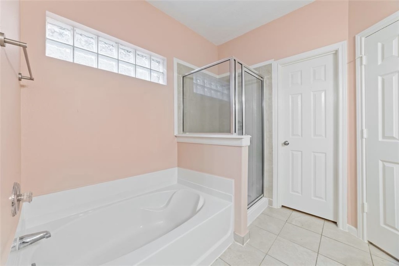 18715 Scented Candle Way Spring, TX 77388 - Photo 20 of 24 a bathroom with a bathtub and shower