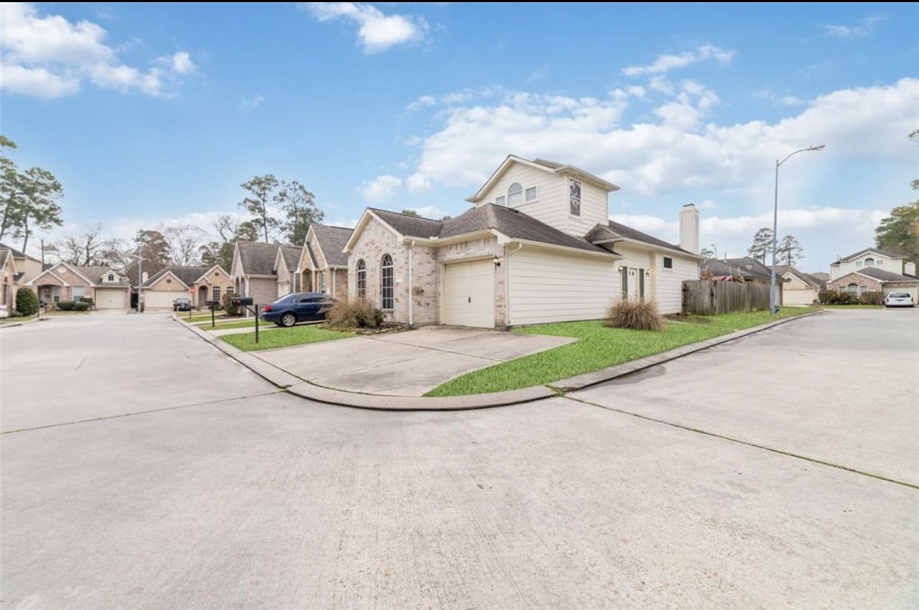 18715 Scented Candle Way Spring, TX 77388 - Photo 2 of 24 a view of a house with a big yard and large trees