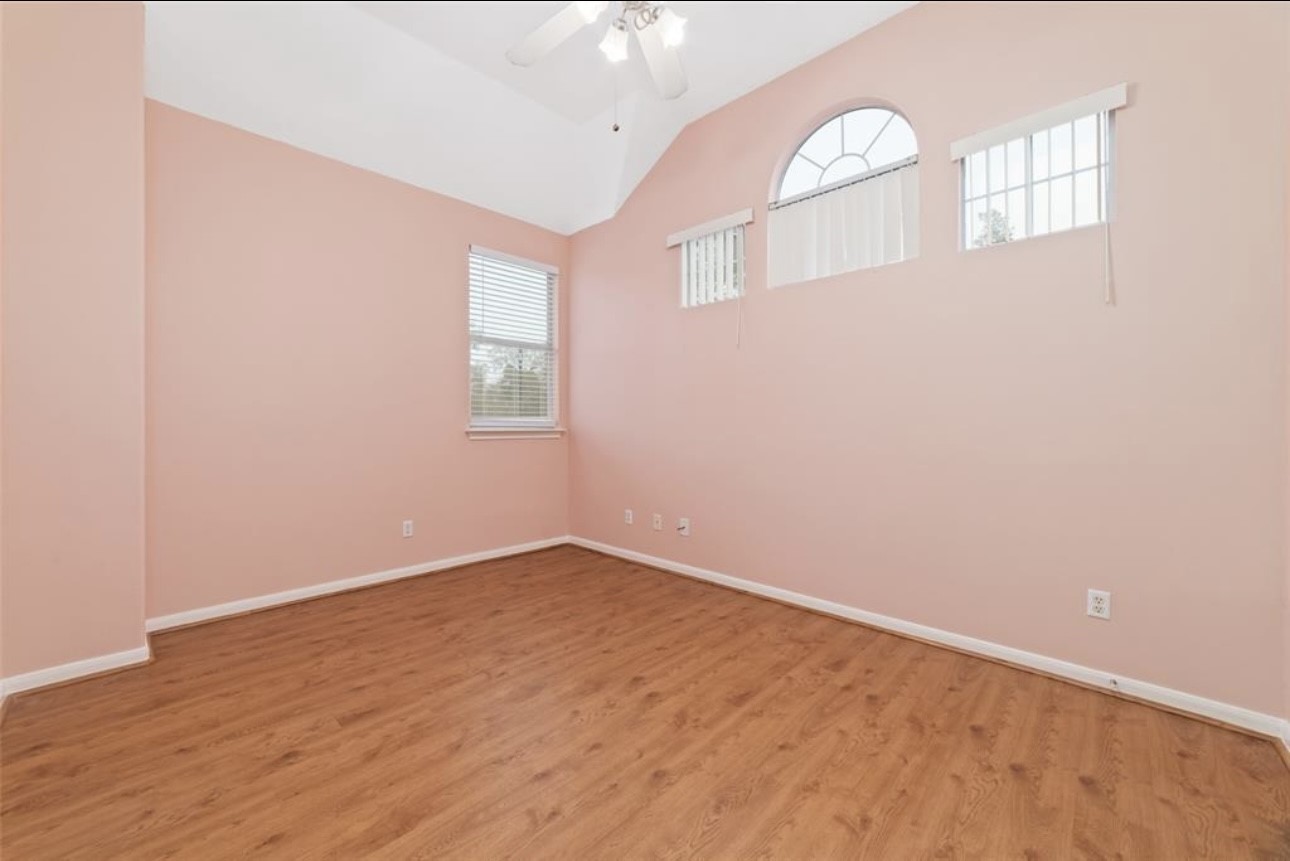 18715 Scented Candle Way Spring, TX 77388 - Photo 22 of 24 an empty room with wooden floor and windows
