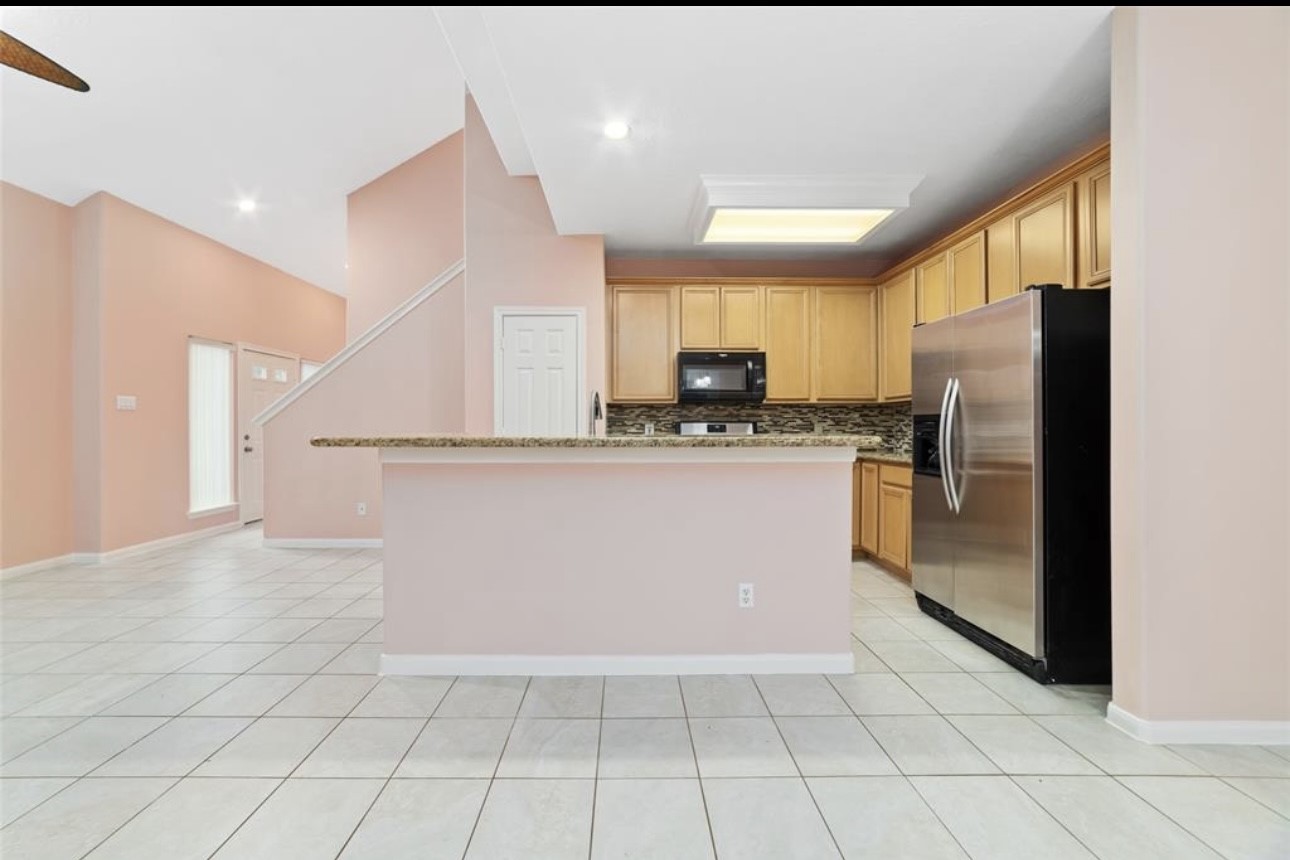 18715 Scented Candle Way Spring, TX 77388 - Photo 9 of 24 a kitchen with stainless steel appliances a refrigerator sink and microwave
