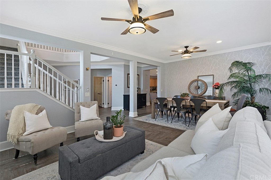 a living room with furniture flowerpot and a chandelier