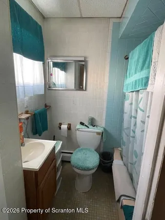 a bedroom with a bed and dresser