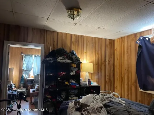 a room with lots of wooden furniture and a window