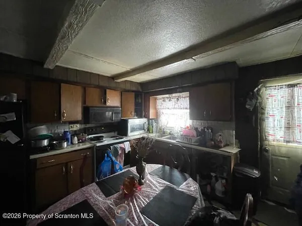 a living room with furniture a flat screen tv and a table