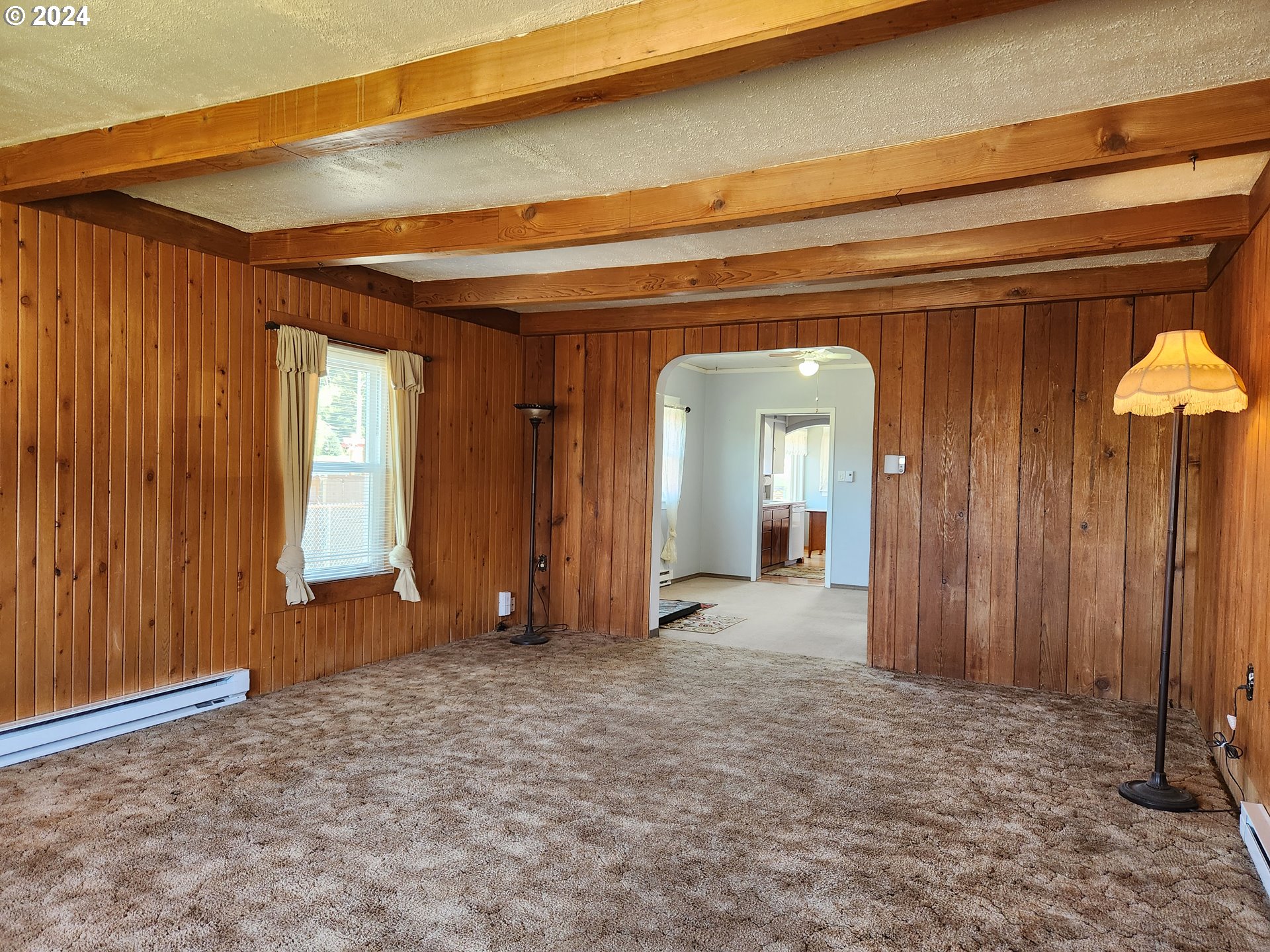 912 Fir Avenue Reedsport, OR 97467 - Photo 12 of 40 a view of a hallway with wooden walls and stairs