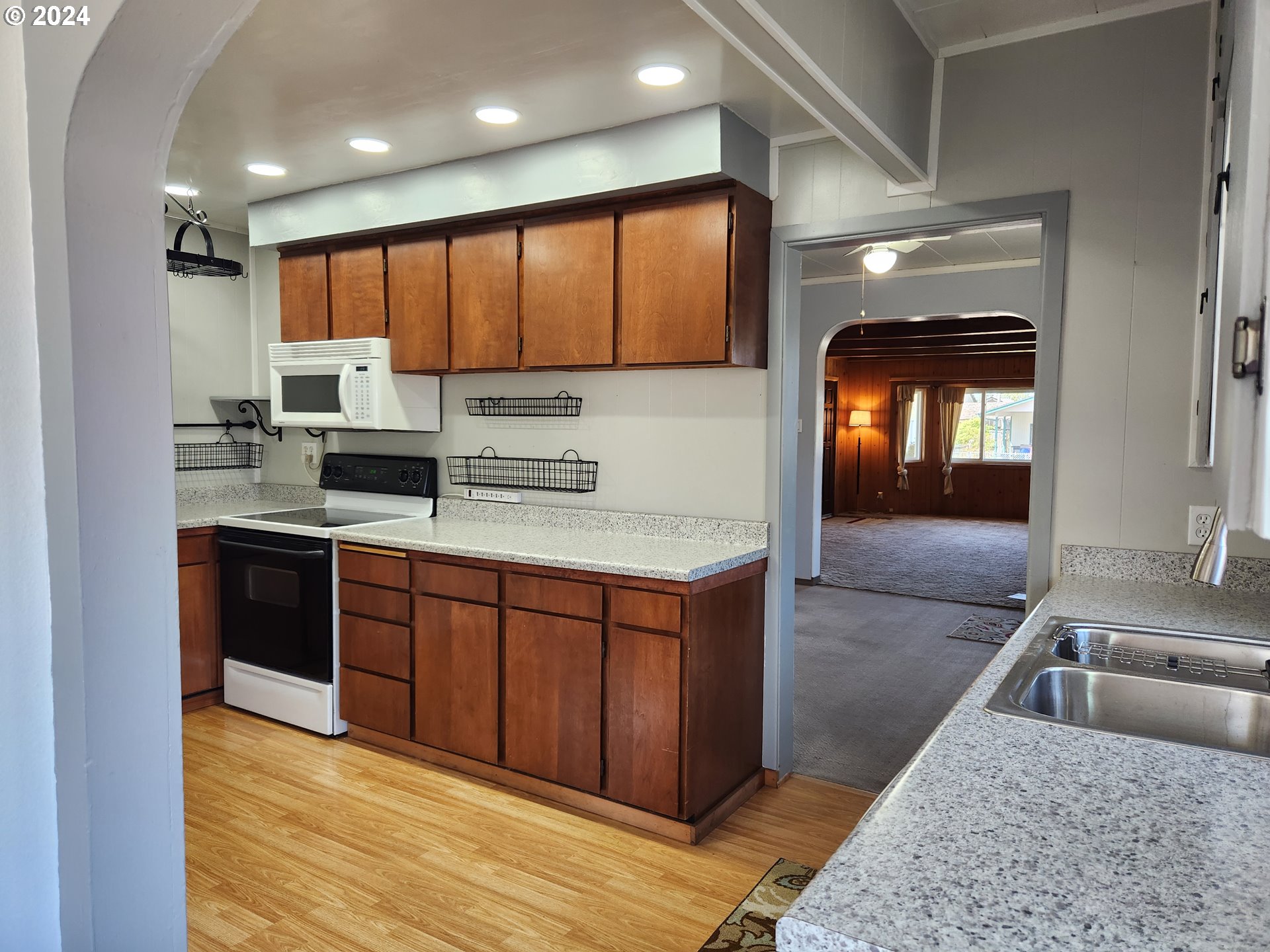 912 Fir Avenue Reedsport, OR 97467 - Photo 19 of 40 a kitchen with stainless steel appliances granite countertop a sink stove and cabinets