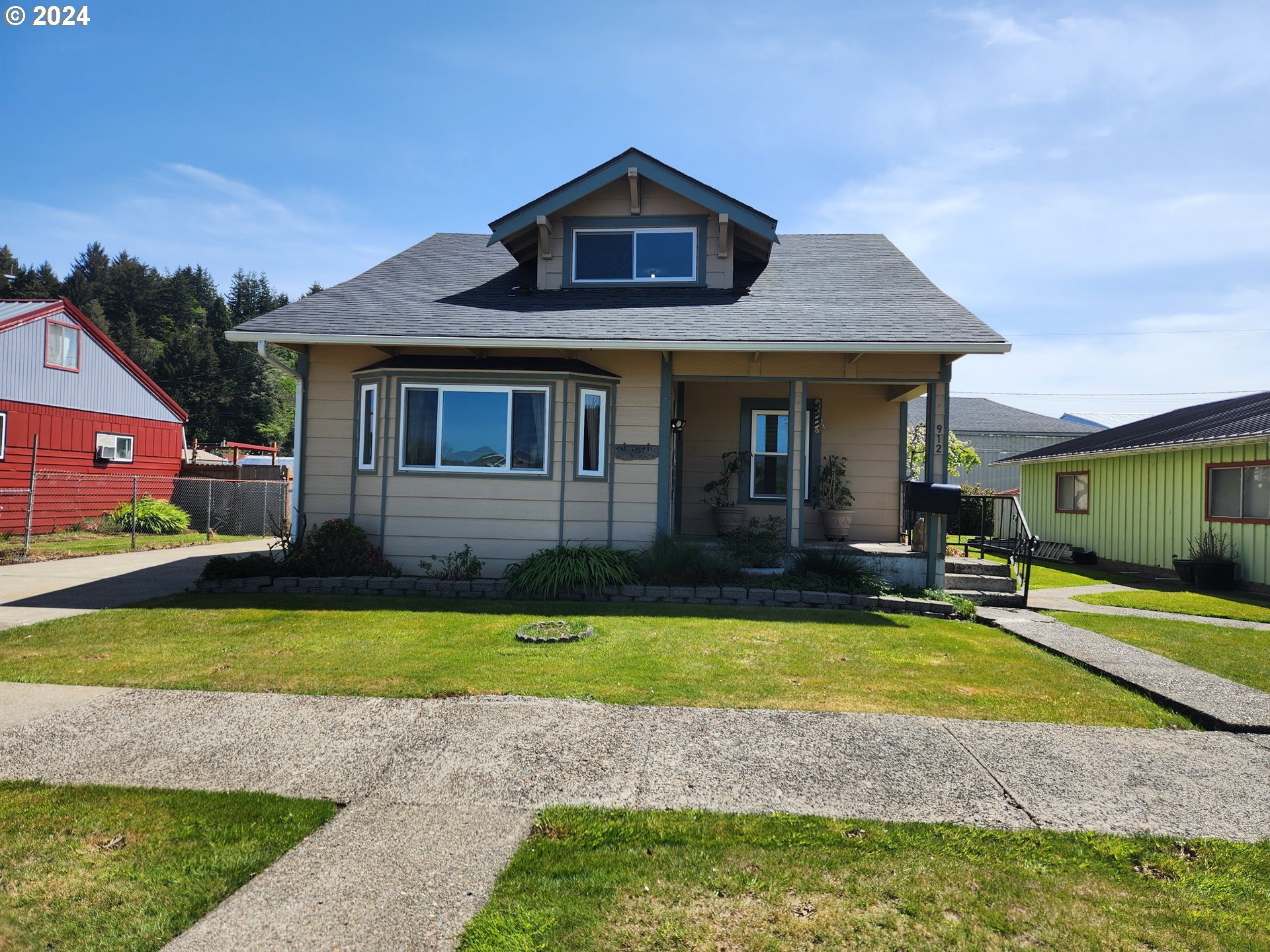 912 Fir Avenue Reedsport, OR 97467 - Photo 2 of 40 a front view of a house with a yard