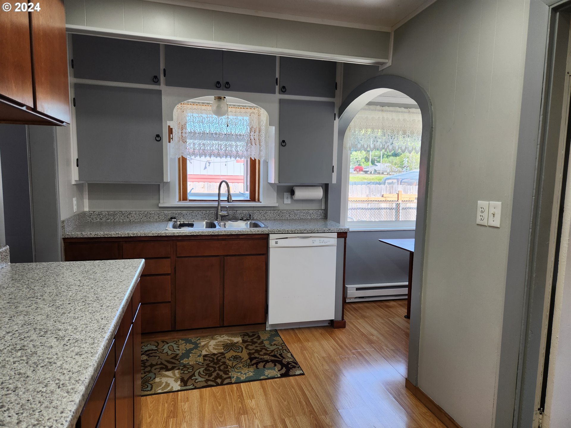 912 Fir Avenue Reedsport, OR 97467 - Photo 21 of 40 a kitchen with granite countertop a sink cabinets and wooden floor