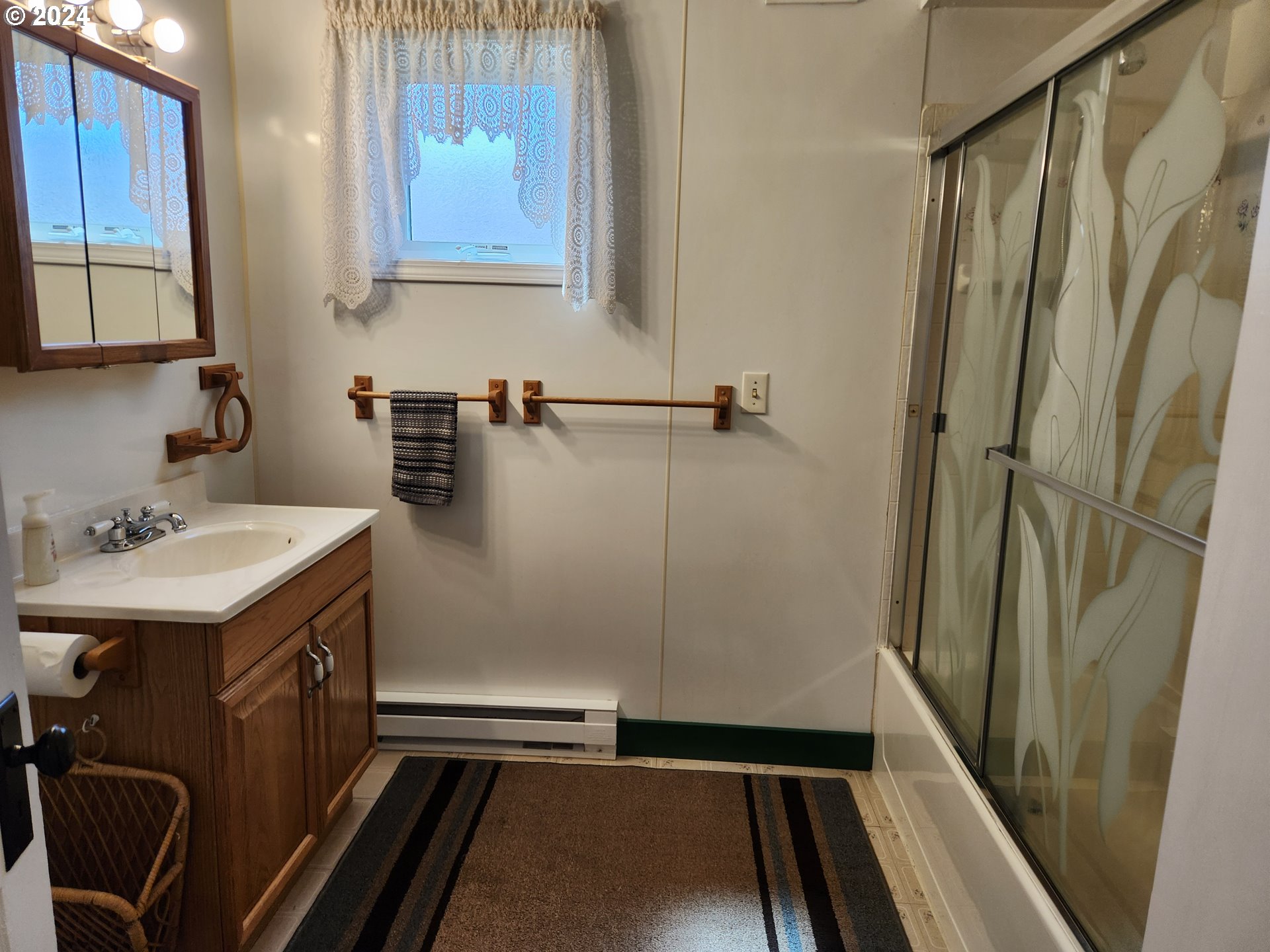 912 Fir Avenue Reedsport, OR 97467 - Photo 24 of 40 a bathroom with a sink and mirror