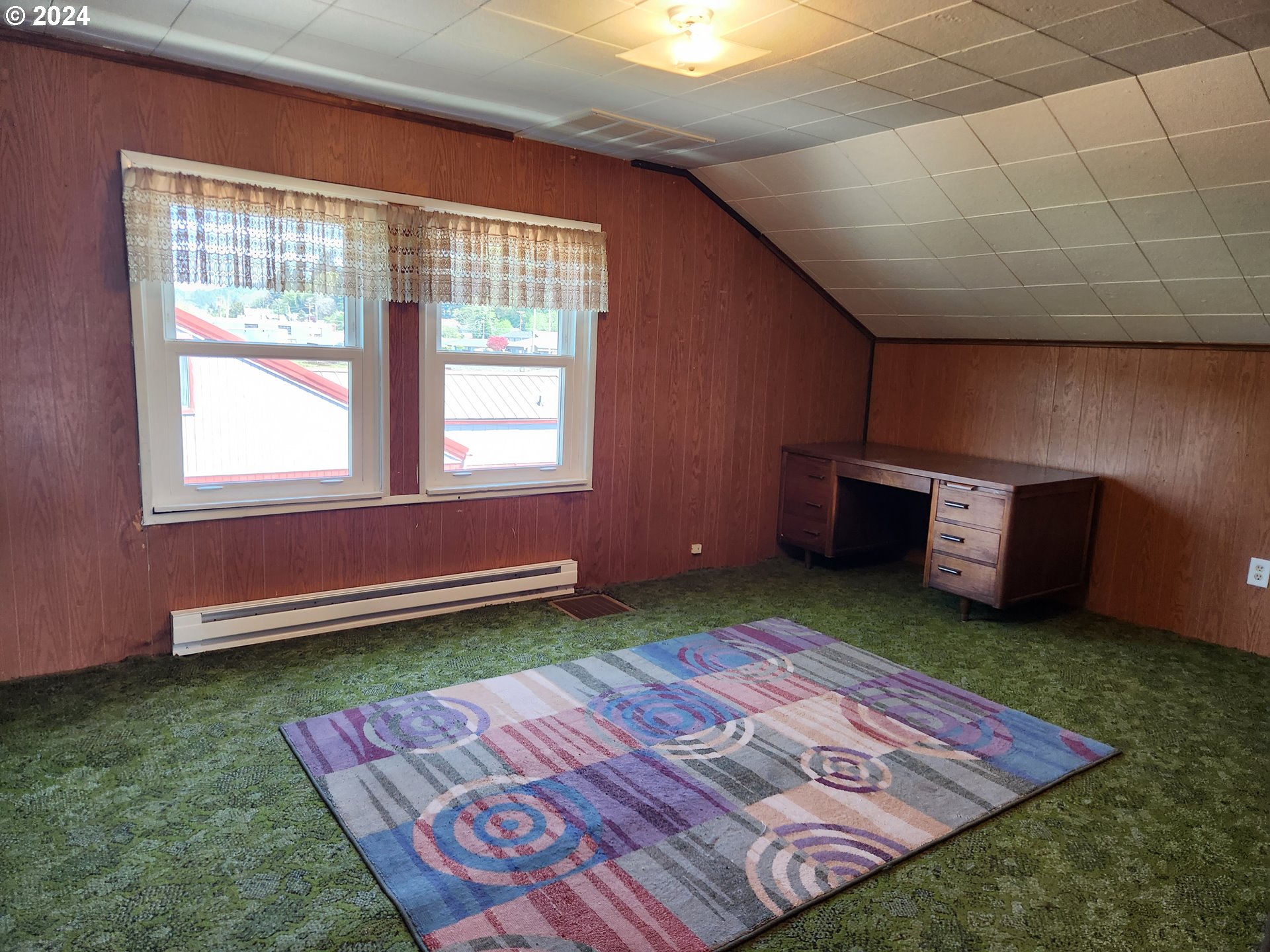 912 Fir Avenue Reedsport, OR 97467 - Photo 34 of 40 a bed sitting in a room next to a window