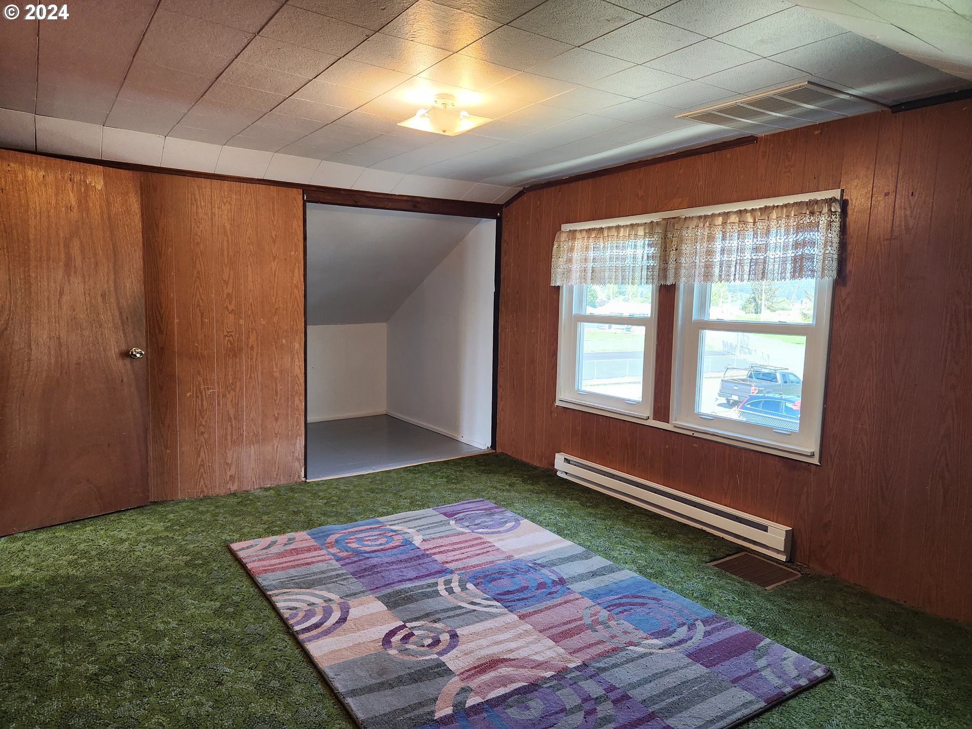 912 Fir Avenue Reedsport, OR 97467 - Photo 35 of 40 a bedroom with a bed and a window