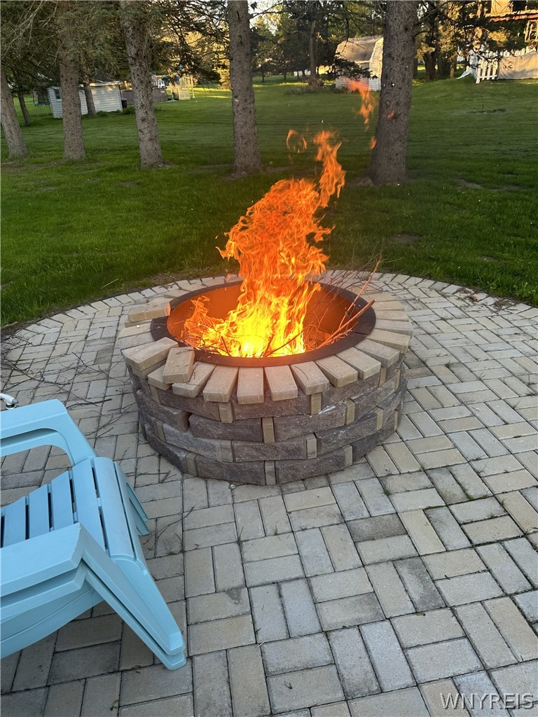 465 Rowley Road Cheektowaga, NY 14043 - Photo 20 of 24 brick fire pit and patio on a cool fall evening