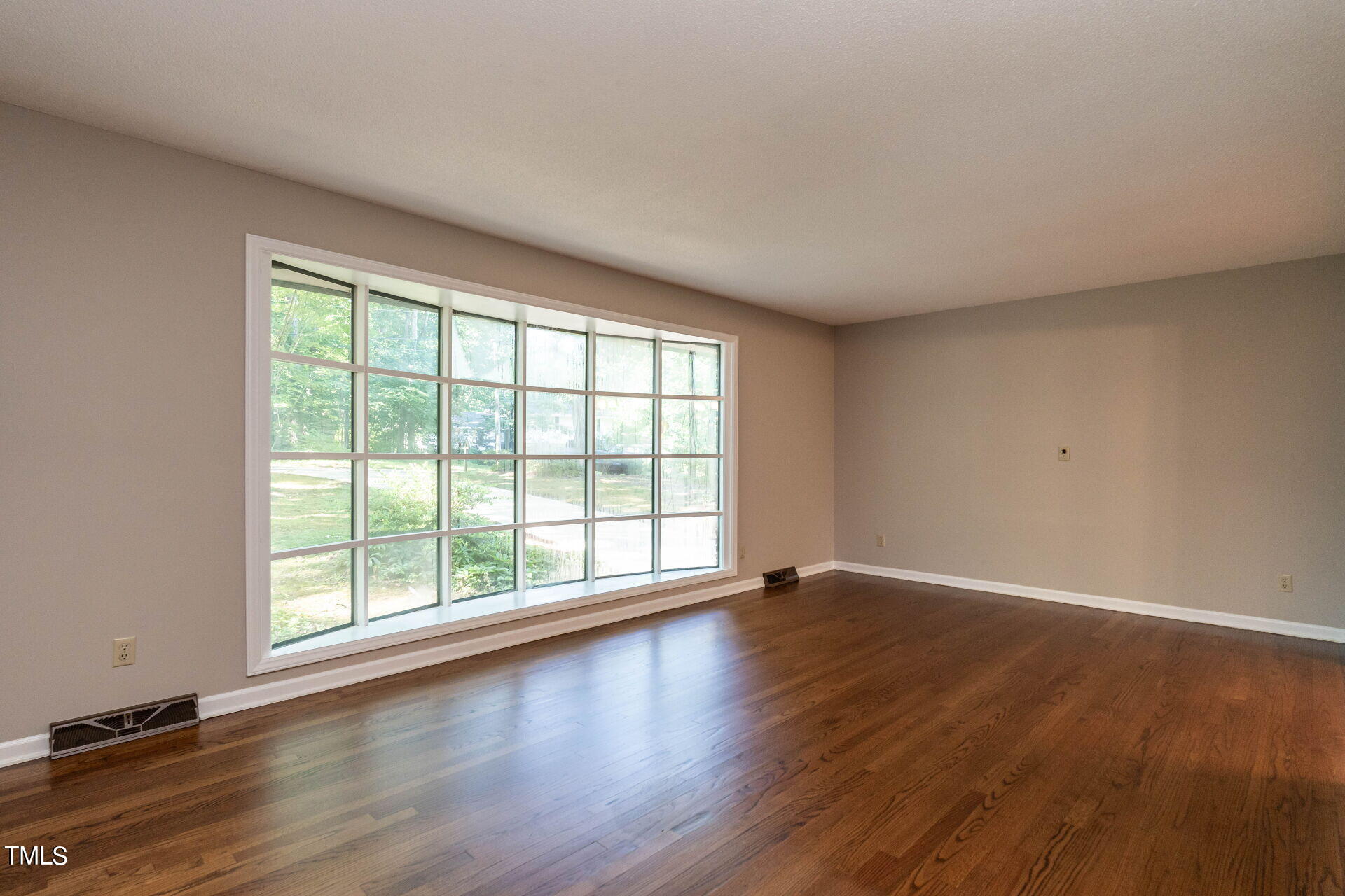 6604 Brandywine Road Raleigh, NC 27607 - Photo 18 of 46 a view of an empty room with wooden floor and a window