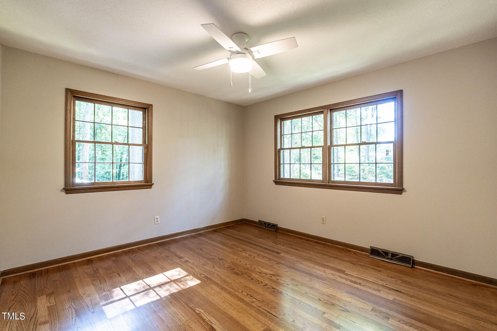 6604 Brandywine Road Raleigh, NC 27607 - Photo 33 of 46 an empty room with wooden floor and windows