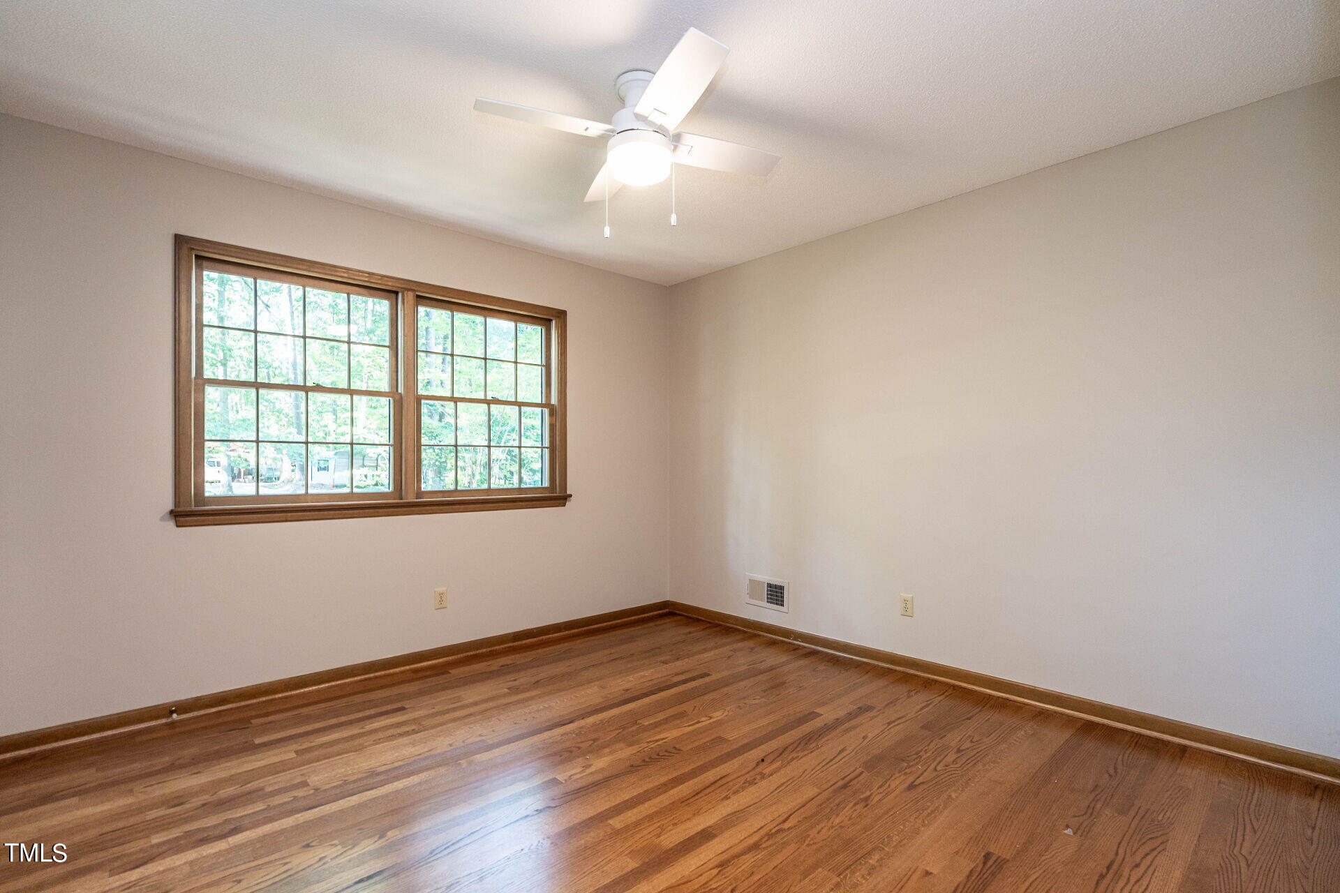 6604 Brandywine Road Raleigh, NC 27607 - Photo 35 of 46 an empty room with wooden floor and windows