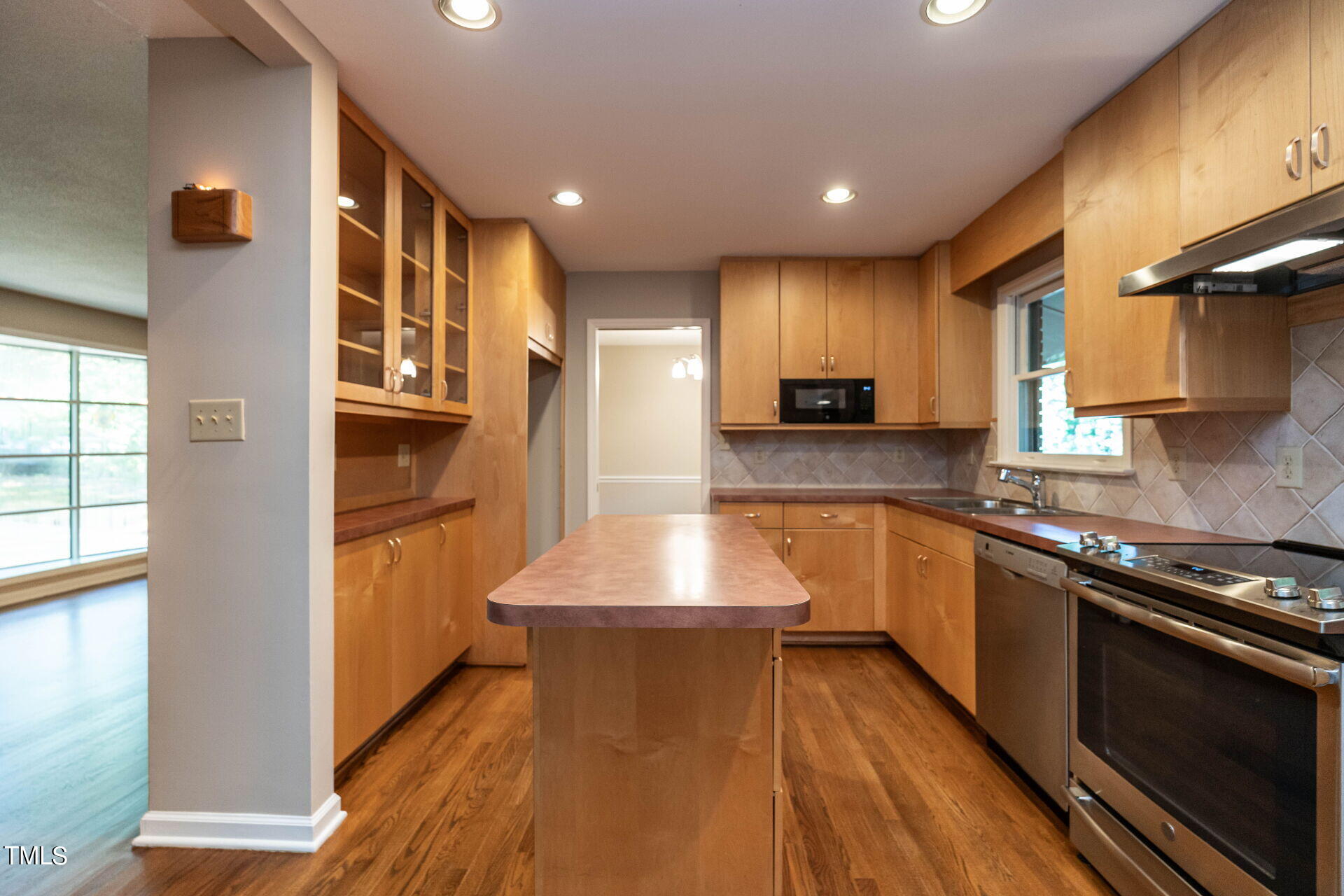 6604 Brandywine Road Raleigh, NC 27607 - Photo 5 of 46 a large kitchen with stainless steel appliances granite countertop a stove a sink and a refrigerator