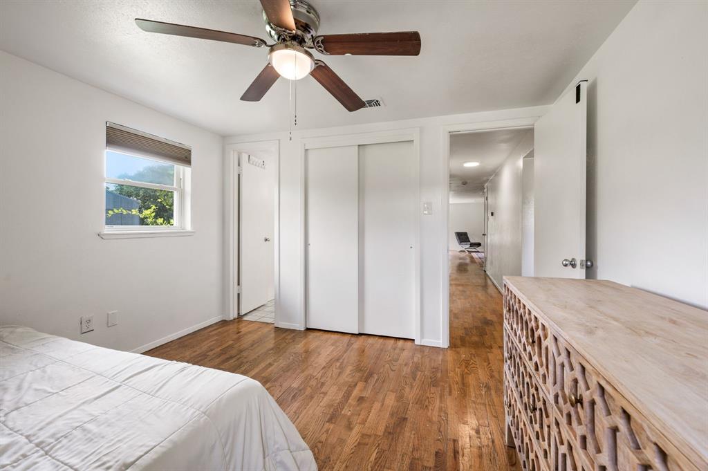 3900 Moseley Road Cross Roads, TX 76227 - Photo 12 of 36 Hardwood-finish flooring throughout, featuring a ceiling fan with integrated lighting, a double-door closet, and a single window with a roller shade